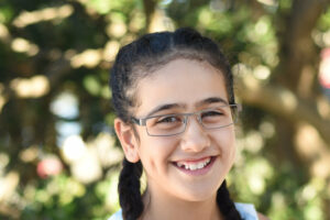 Smiling child wearing glasses & prescription lenses by Mr Foureyes